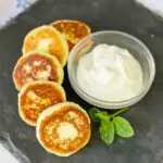 Cheese Pancakes on the display board with a bowl of sour cream