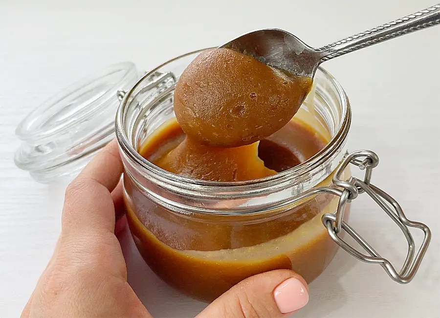 Spoon of thick caramel sauce
