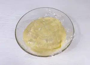 Custard filling in the bowl covered with plastic wrap