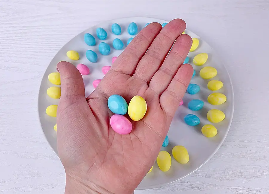 Hand is holding Marshmallow eggs 