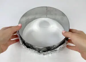 Baking ring covered with parchment paper and foil