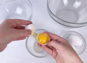 Separating the eggs into egg whites and yolks